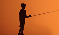 Silhouette of a Boy With a Fishing Rod on Sea Presentation Presentation Template