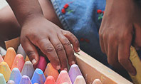 Toddlers are Playing with Full Box of Colored Chalk Presentation Presentation Template