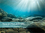 Sunbeams Underwater with Rocks on the Seabed Presentation slide 1
