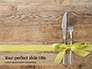 Knife and Fork with Gift Ribbon on Wooden Surface Presentation slide 1