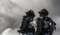 Two Firefighters Standing Beside Smoke Presentation Presentation Template