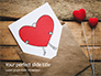 Love Letter Envelope with Red Heart on Wooden Table Presentation slide 1