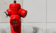 A Deep Red Fire Hydrant in Front of a Wall Presentation Presentation Template